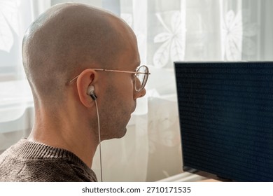 Programmer, young man in brown cable knit sweater working at computer, coding process, modern worker solving problems, specialist digital tasks, home office environment promoting productivity and calm