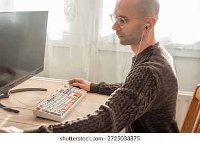 Programmer, young man in brown cable knit sweater working at computer, coding process, modern worker solving problems, specialist digital tasks, home office environment promoting productivity and calm