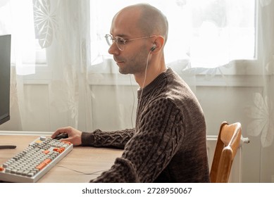 Programmer, young man in brown cable knit sweater working at computer, coding process, modern worker solving problems, specialist digital tasks, home office environment promoting productivity and calm