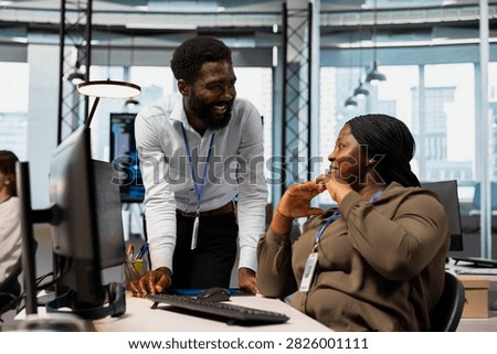 Programmers chat and smile while reviewing code snippets, adjusting configurations, and running diagnostic tools on a computer in an office