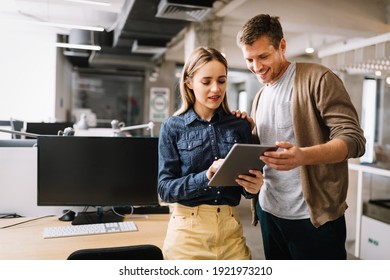 Programmers cooperating at IT company developing apps