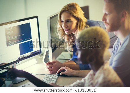 Programmers cooperating at  IT company developing apps