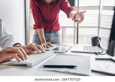 Programmers cooperating at Developing programming and website working in a software develop company office, writing codes and typing data code, Programming with HTML, PHP and javascript.