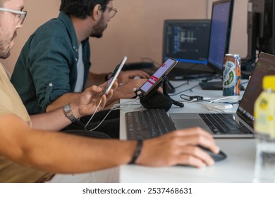 Programmers engrossed in deep collaboration, diligently working together to solve complex problems and develop innovative mobile applications with seamless functionality.