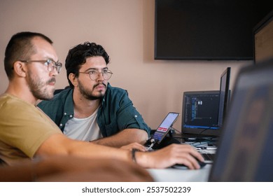 Programmers engrossed in deep collaboration, diligently working together to solve complex problems and develop innovative mobile applications with seamless functionality.
