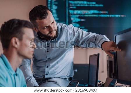 Programmers engrossed in deep collaboration, diligently working together to solve complex problems and develop innovative mobile applications with seamless functionality.