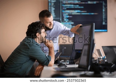 Programmers engrossed in deep collaboration, diligently working together to solve complex problems 