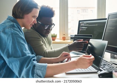 Programmers working with new software in team