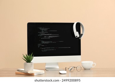 Programmer's workplace. Modern computer with unfinished code on desk