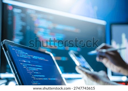 Programmers are writing computer code to develop applications or websites using JavaScript and C++ programming languages, and testing them to ensure the system works efficiently on their smartphones.