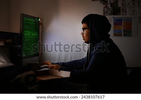 Programming, computer and man with hacker, night or cyber security with online database, malware or password phising. Person, IT programmer or ransomware developer with pc or website server with code
