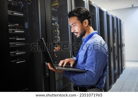 Programming, data center and a man with a laptop for maintenance, cyber security and internet check. Coding, email and an Asian programmer typing on a computer for network or server analytics