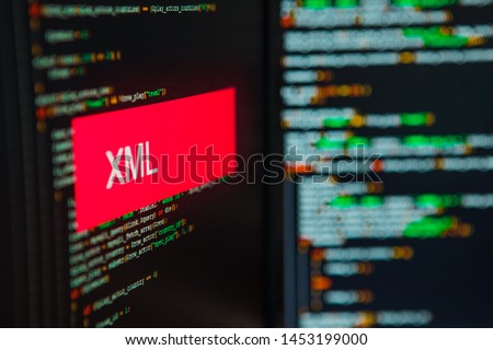 Programming language, XML inscription on the background of computer code. Modern digital technologies and programming training