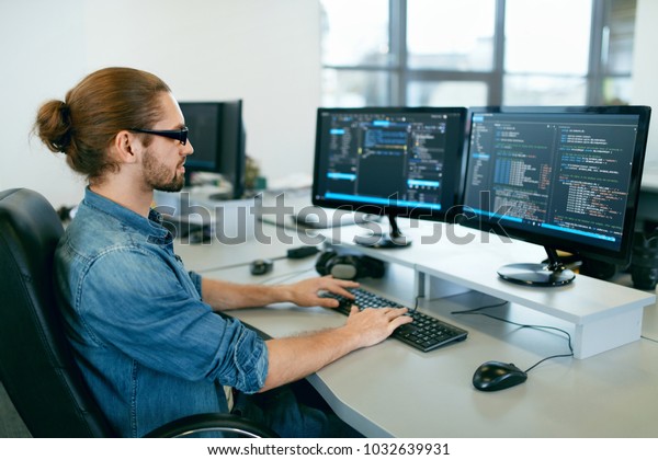 Programming. Man\
Working On Computer In IT Office, Sitting At Desk Writing Codes.\
Programmer Typing Data Code, Working On Project In Software\
Development Company. High Quality\
Image.