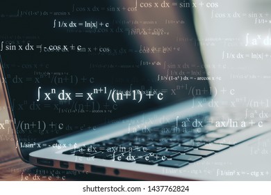 Programming and technology concept. Close up of blurry laptop with mathematical formulas. Multiexposure 