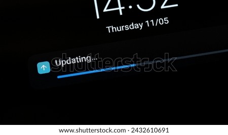 Progress bar indicating an ongoing OS operating system update on a generic mobile device, smartphone, tablet, nobody, screen display macro detail closeup shot. Updating software abstract concept
