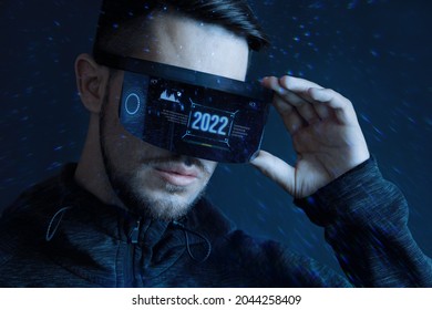 Progress bar loading 2022 year. Man with futuristic tablet in hand. Guy using VR glasses. Augmented reality, future technology concept. Futuristic holographic loading interface.