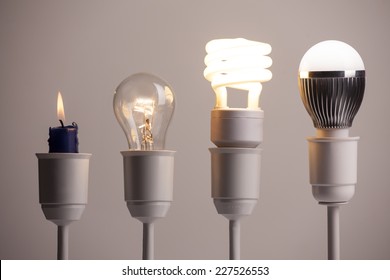 Progress Of Lighting Displayed With Candle, Tungsten, Fluorescent And LED Bulb