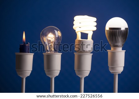 Progress of lighting displayed with candle, tungsten, fluorescent and LED bulb