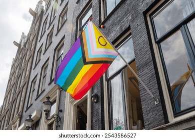 Progress Pride flag displayed on the exterior of a historic building