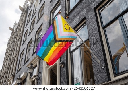 Progress Pride flag displayed on the exterior of a historic building