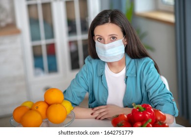 Prohibited products. A woman wearing a mask while working with allergy causing products - Shutterstock ID 1642751779