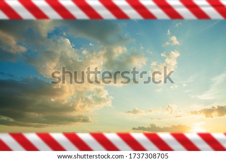 Prohibition and despotism concept with sky, clouds and warning tape