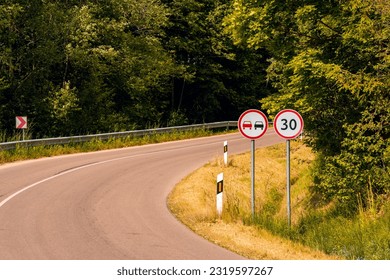 Prohibition road sign No Overtaking and road sign Speed Limit on the curved road. Safety on the road.