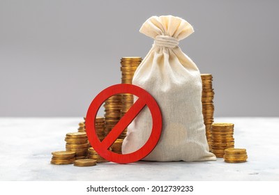 Prohibition Sign. Money Bag And Stacks Of Coins On A Gray Background. No Symbol And Money.