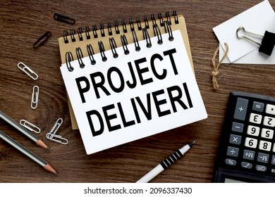 PROJECT DELIVER. two notebooks with a spring on a wooden background with a pencil calculator pen business concept. Office concept. View from above. - Shutterstock ID 2096337430
