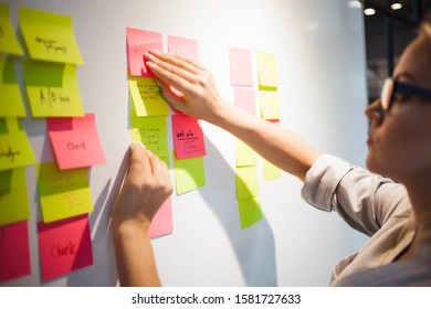 project management, agile methodology. young business woman in the office are planning product development and support. Project manager glue sticky stickers on the Board