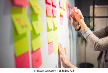 project management, agile methodology. young business woman in the office are planning product development and support. Project manager glue sticky stickers on the Board - Shutterstock ID 1588102723