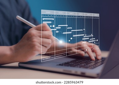 Project management concept. Site manager working with Gantt chart schedule for plan tasks and progress. Planning software. Corporate strategy for construction, finance, operations, sales, marketing.