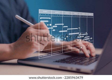 Project management concept. Site manager working with Gantt chart schedule for plan tasks and progress. Planning software. Corporate strategy for construction, finance, operations, sales, marketing.