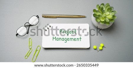 Project management is the process of planning, organizing, and controlling resources to achieve specific goals within set timeframes and budgets. Notes with the word