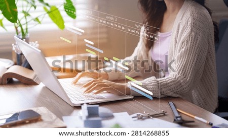 Project management software and digital planning concept with professional woman working on laptop with virtual