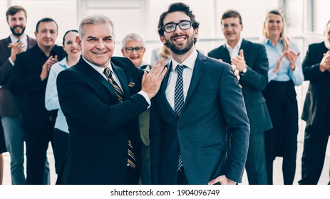 project Manager congratulating the best employee on the victory