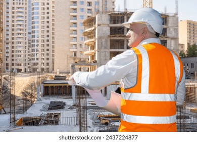 Project Manager Overseeing Construction Progress at Urban Building Site