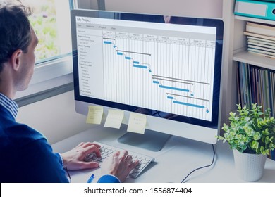 Project manager working on Gantt chart schedule to create planning with tasks and milestones to plan activities, person working with management tools on computer in office