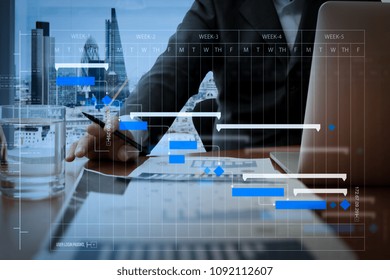 Project Manager Working And Update Tasks With Milestones Progress Planning And Gantt Chart Scheduling Diagram.business Documents On Office Table With Smart Phone And Digital Tablet.