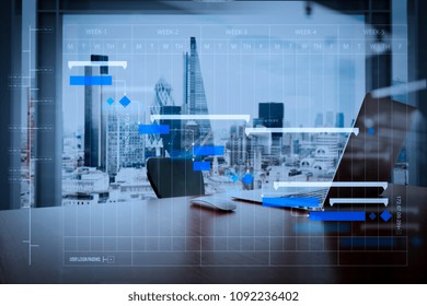 Project Manager Working And Update Tasks With Milestones Progress Planning And Gantt Chart Scheduling Diagram.Office Workplace With Laptop And Smart Phone On Wood Table With London City Background.

