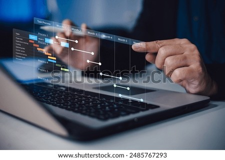 Project manager working and update tasks with milestones progress planning. Businessman using laptop computer plan schedule virtual diagram, business project management concept.
