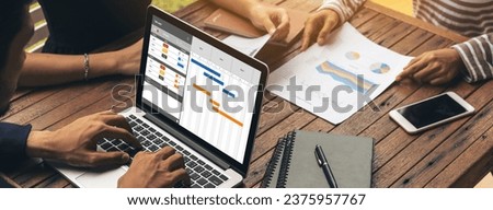 Project planning software for modish business project management on the computer screen showing timeline chart of the team project