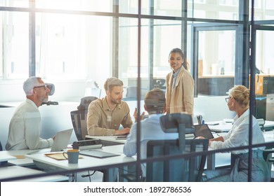 Project Team At Work. Group Of Multiracial Business People Sitting In Board Room In The Modern Office And Discussing Something While Having A Meeting