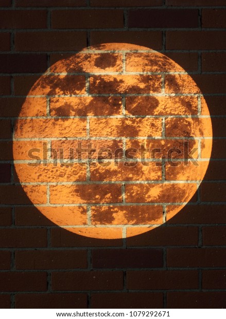  projection\
of moon surface onto a brick\
wall