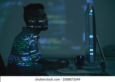 Projection of programming code on Indian software developer - Shutterstock ID 1008873349