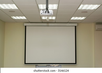 Projection Screen In The Boardroom With Overhead Projector In Office