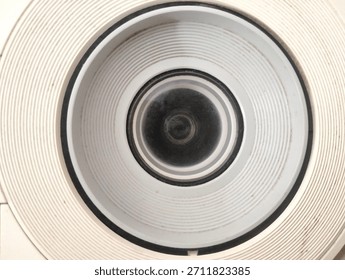 projector camera lens inside a white striped circle