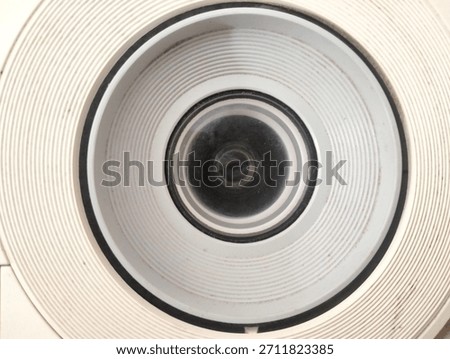 projector camera lens inside a white striped circle