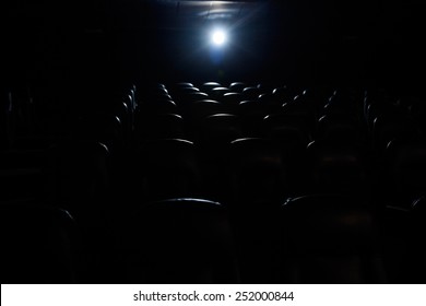 Projector Light In Empty Movie Theater